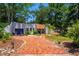 Single story home surrounded by lush landscaping with winding brick driveway at 640 Sailfish Rd, Winter Springs, FL 32708