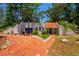 Charming home showcasing a beautiful red brick driveway, complemented by lush greenery and a blue garage door at 640 Sailfish Rd, Winter Springs, FL 32708