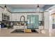 Bright kitchen featuring a stainless steel faucet and white cabinets with a blue refrigerator at 640 Sailfish Rd, Winter Springs, FL 32708