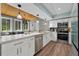 Modern kitchen with white cabinets, stainless steel appliances, and wood-look floors at 640 Sailfish Rd, Winter Springs, FL 32708