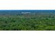 Scenic aerial view showcasing lush greenery surrounding a distant building, providing a tranquil and natural backdrop at 640 Sailfish Rd, Winter Springs, FL 32708