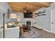 Comfortable living room with a fireplace, wood ceiling, and stylish decor, perfect for relaxation at 640 Sailfish Rd, Winter Springs, FL 32708