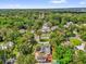The property sits among mature trees in a vibrant neighborhood, as seen from above at 647 E 3Rd Ave, Mount Dora, FL 32757