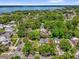 Aerial view of property close to the lake, surrounded by lush trees and greenery at 647 E 3Rd Ave, Mount Dora, FL 32757