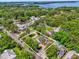 Aerial view showcases the property's layout and proximity to a lake at 647 E 3Rd Ave, Mount Dora, FL 32757