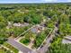 Aerial view showcasing the property's circular driveway and lush greenery of the surrounding neighborhood at 647 E 3Rd Ave, Mount Dora, FL 32757