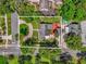 Aerial view of the property highlighting its lush landscaping and circular driveway at 647 E 3Rd Ave, Mount Dora, FL 32757