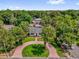 Beautiful home surrounded by lush greenery, with a circular brick driveway adding to its curb appeal at 647 E 3Rd Ave, Mount Dora, FL 32757