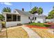 View of the home's charming backyard with a screened porch and vibrant red outdoor seating area at 647 E 3Rd Ave, Mount Dora, FL 32757