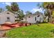 Backyard featuring patio, outdoor seating, hammock, grass, and white detached unit at 647 E 3Rd Ave, Mount Dora, FL 32757
