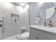 Modern bathroom featuring a tiled shower, updated vanity, and sleek fixtures at 647 E 3Rd Ave, Mount Dora, FL 32757