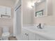 Traditional bathroom with shower featuring a single sink vanity and updated toilet at 647 E 3Rd Ave, Mount Dora, FL 32757