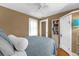 Bedroom featuring warm paint, a ceiling fan and built in shelving at 647 E 3Rd Ave, Mount Dora, FL 32757