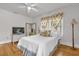 Well-lit bedroom featuring hardwood floors and floral window treatments at 647 E 3Rd Ave, Mount Dora, FL 32757