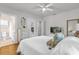Comfortable bedroom with white bedspread and an ensuite bathroom at 647 E 3Rd Ave, Mount Dora, FL 32757