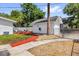 A detached one-car garage and red patio area enhance the home's outdoor appeal at 647 E 3Rd Ave, Mount Dora, FL 32757
