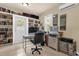 Home office with built in shelving, multiple monitors, and natural light at 647 E 3Rd Ave, Mount Dora, FL 32757