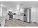 Spacious kitchen featuring stainless steel appliances, ample white cabinetry, and stylish backsplash at 647 E 3Rd Ave, Mount Dora, FL 32757