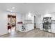 Bright kitchen with white cabinets, stainless steel appliances, and wood-look tile flooring at 647 E 3Rd Ave, Mount Dora, FL 32757