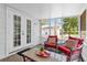 Relax on the screened patio, perfect for enjoying the outdoors with comfortable seating at 647 E 3Rd Ave, Mount Dora, FL 32757