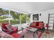 Enjoy the outdoor screened patio with comfortable seating and scenic backyard views at 647 E 3Rd Ave, Mount Dora, FL 32757
