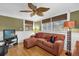 Comfortable sitting room with a unique ceiling fan, hardwood floors, and ample natural light at 647 E 3Rd Ave, Mount Dora, FL 32757