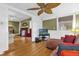 Sitting area with hardwood floors, a unique ceiling fan, and connected to the living room at 647 E 3Rd Ave, Mount Dora, FL 32757