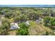 An aerial perspective highlights houses with solar panels in a wooded setting, blending sustainability at 6710 Winkles St, Coleman, FL 33521