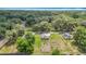 Aerial view shows houses with spacious lots, situated near roads in a heavily wooded area at 6710 Winkles St, Coleman, FL 33521
