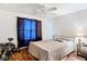 Bedroom with fan, window, dark curtains, bed, and side table at 6710 Winkles St, Coleman, FL 33521