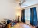 Bedroom with ceiling fan, window, and dark curtains at 6710 Winkles St, Coleman, FL 33521