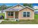 Attractive single-story home featuring a welcoming entrance and well-maintained front yard in a quiet neighborhood at 6710 Winkles St, Coleman, FL 33521