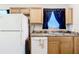 Kitchen with laminate countertop, stainless steel sink and fixtures with white appliances at 6710 Winkles St, Coleman, FL 33521