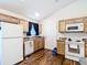 Functional kitchen featuring a full appliance suite, warm cabinets, and ample counter space for meal preparation at 6710 Winkles St, Coleman, FL 33521