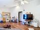 Open-concept living room with hardwood floors connects seamlessly to the kitchen, creating a welcoming and functional space at 6710 Winkles St, Coleman, FL 33521