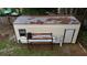 An outdoor shed and storage rack sits in the backyard at 705 Poinsettia Ave, Fruitland Park, FL 34731
