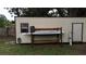 An outdoor shed and storage rack sits in the backyard at 705 Poinsettia Ave, Fruitland Park, FL 34731