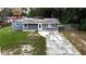 Charming single-story home featuring a manicured lawn and quaint curb appeal at 705 Poinsettia Ave, Fruitland Park, FL 34731
