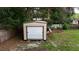 A metal shed with a garage-style door for parking and storage at 705 Poinsettia Ave, Fruitland Park, FL 34731