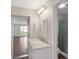 Updated bathroom features marble countertops, modern lighting, and a glass enclosed shower at 7378 Ne 49Th Ln, Wildwood, FL 34785