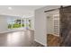 Bright bedroom features wood-look flooring and a barn door leading to the closet at 7378 Ne 49Th Ln, Wildwood, FL 34785