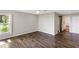 Bright bedroom features wood-look flooring, a barn door to the ensuite, and large windows at 7378 Ne 49Th Ln, Wildwood, FL 34785