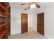 Bedroom featuring built-in wooden shelving, a closet, tile floors, and a doorway to another room at 7378 Ne 49Th Ln, Wildwood, FL 34785