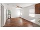 Open bonus room featuring wood-look flooring, bright white walls, and a ceiling fan at 7378 Ne 49Th Ln, Wildwood, FL 34785