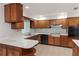 Traditional kitchen with wooden cabinetry, white countertops, and tile flooring at 7378 Ne 49Th Ln, Wildwood, FL 34785