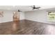 Open living space with wood-look tile flooring, recessed lighting, ceiling fans, and natural light at 7378 Ne 49Th Ln, Wildwood, FL 34785