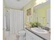 Bathroom with light green wall and decorative mirror frame at 762 Turbeville Ter, The Villages, FL 32162
