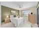 Bedroom with light green walls, ceiling fan, and neutral carpet at 762 Turbeville Ter, The Villages, FL 32162