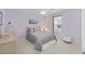 Cozy bedroom with a gray bed, neutral carpet and a ceiling fan at 762 Turbeville Ter, The Villages, FL 32162