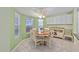 Bright breakfast nook with a round table, ample windows, and built-in cabinetry at 762 Turbeville Ter, The Villages, FL 32162